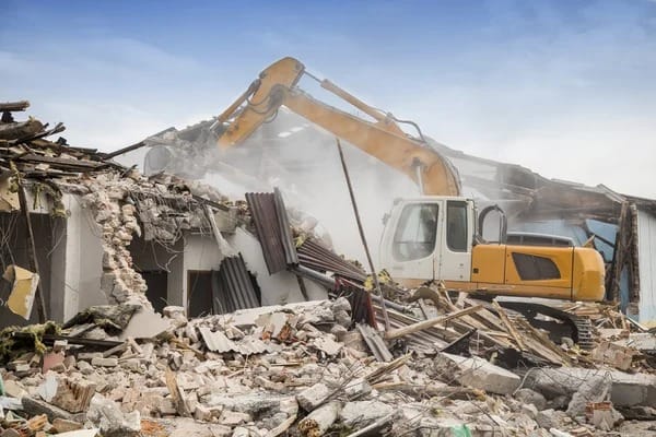 depositphotos_81557390-stock-photo-excavator-demolishing-barracks.jpg